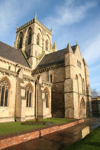 A historic stone building with arched windows and a tower.
