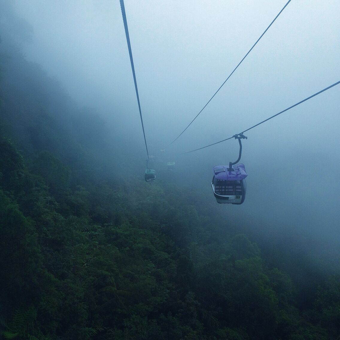 This is a view of Genting Skyway Cable Car, Malaysia. As you can see the fog is all over the mountain on the way downhill. This Cable Car takes us from the terminal at downhill to the Genting Highland where the Genting Casino lies, and back to downhill.