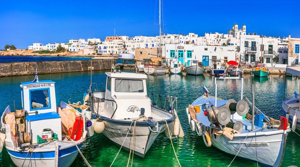 Greece travel. Cyclades, Paros island. Charming fishing village Naoussa. view of old port with boats and street taverns by the sea. may 2021