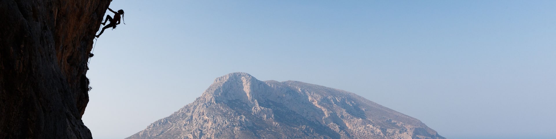 Silhouette of woman climbing on Greek island of Kalmynos
