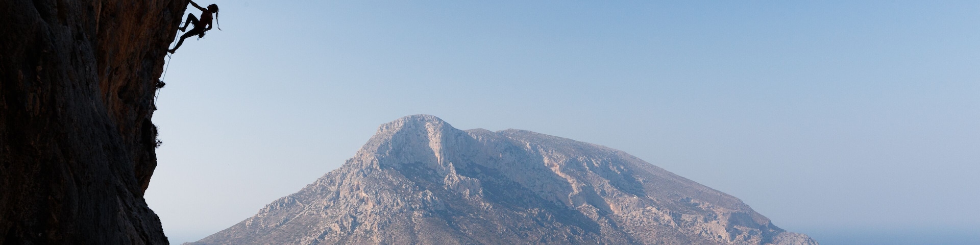 Silhouette of woman climbing on Greek island of Kalmynos