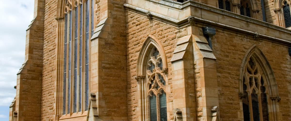 A historic church with pointed arches and a slate roof.