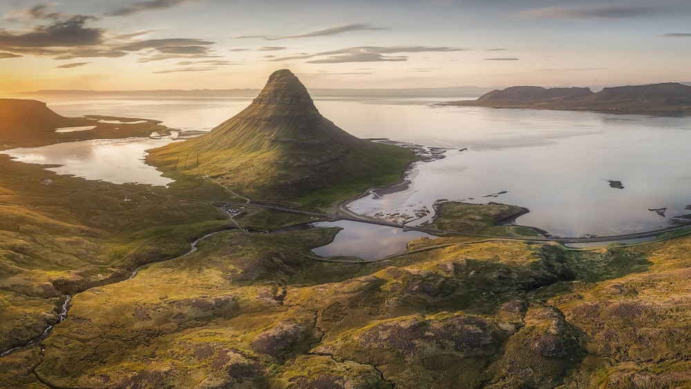 Aerial view of the majestic Kirkjufell mountain under the golden sunset light, Grundarfjordur, Grundarfjardarbaer, Iceland.