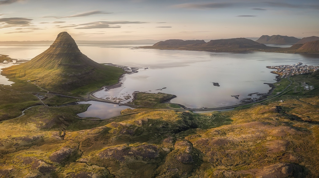 Aerial view of the majestic Kirkjufell mountain under the golden sunset light, Grundarfjordur, Grundarfjardarbaer, Iceland.