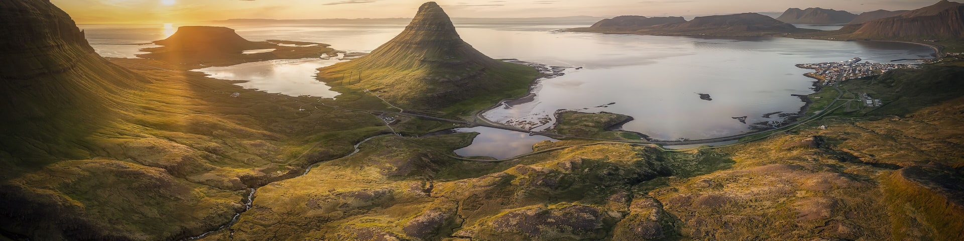 Aerial view of the majestic Kirkjufell mountain under the golden sunset light, Grundarfjordur, Grundarfjardarbaer, Iceland.