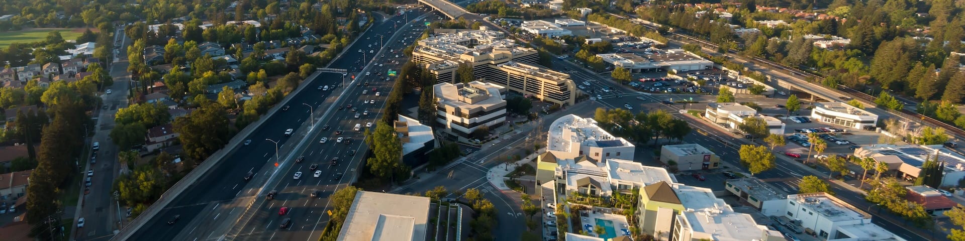 Aerial view of a busy I-680 highway in Walnut Creek, California, USA. Cars and trucks are commuting during the day, showcasing the region's infrastructure and traffic patterns.