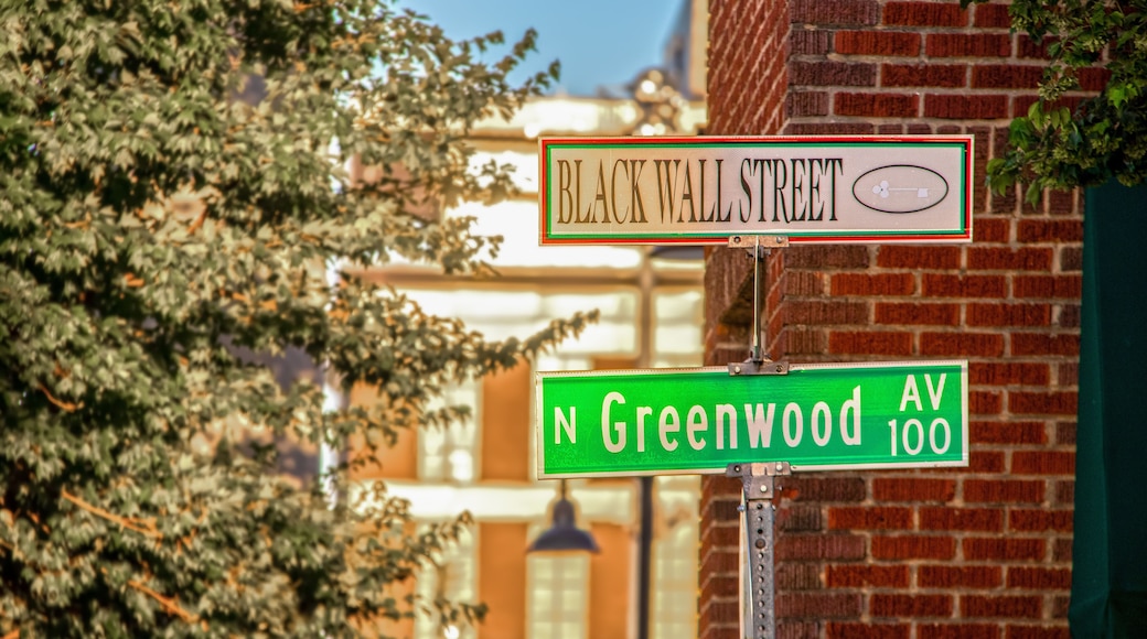 Black Wall Street and N Greenwood Avenue street signs - closeup - in Tulsa Oklahoma with bokeh background
