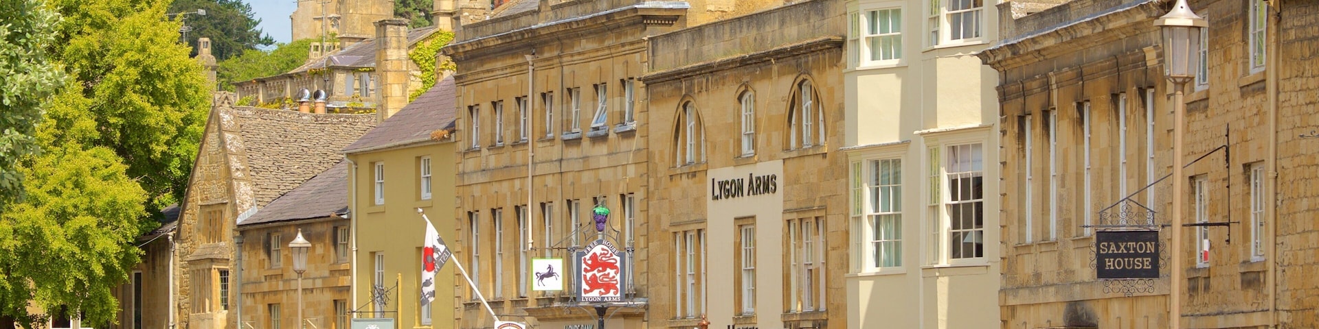 A street lined with historic buildings, including a hotel and a bank.