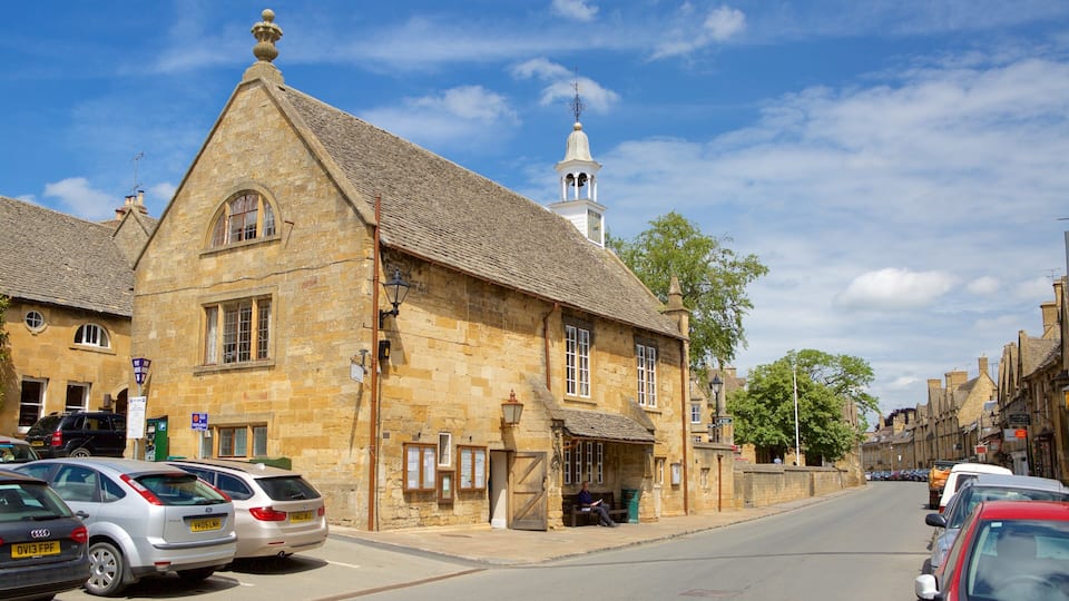 A historic stone building with a steeply pitched roof and a bell tower.