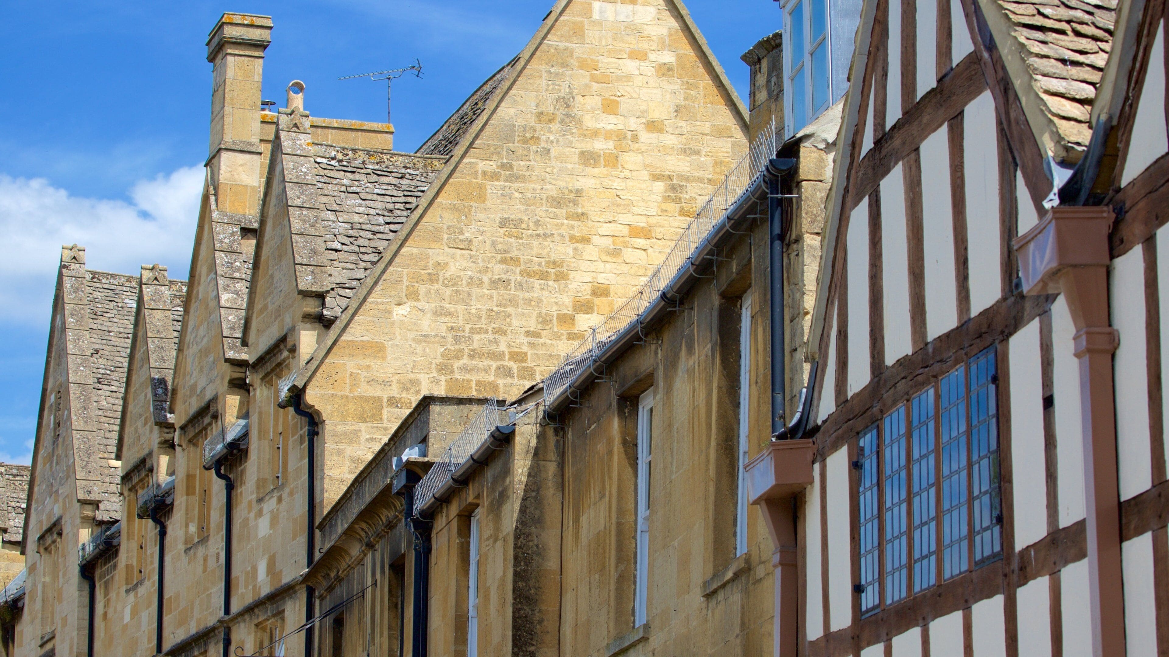 A row of historic stone buildings with timber framing.