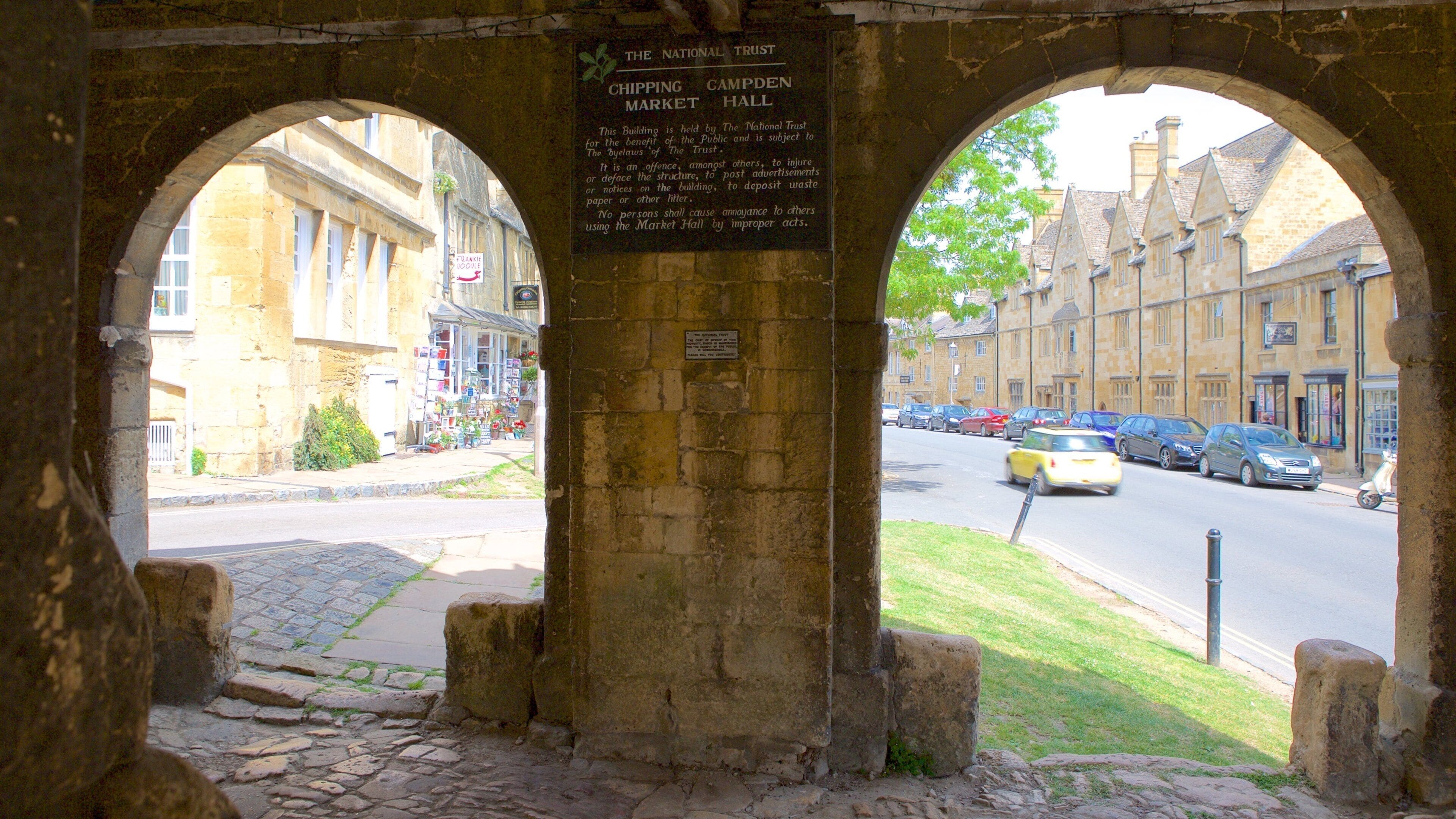 An archway with a sign for Chipping Campden Market Hall.