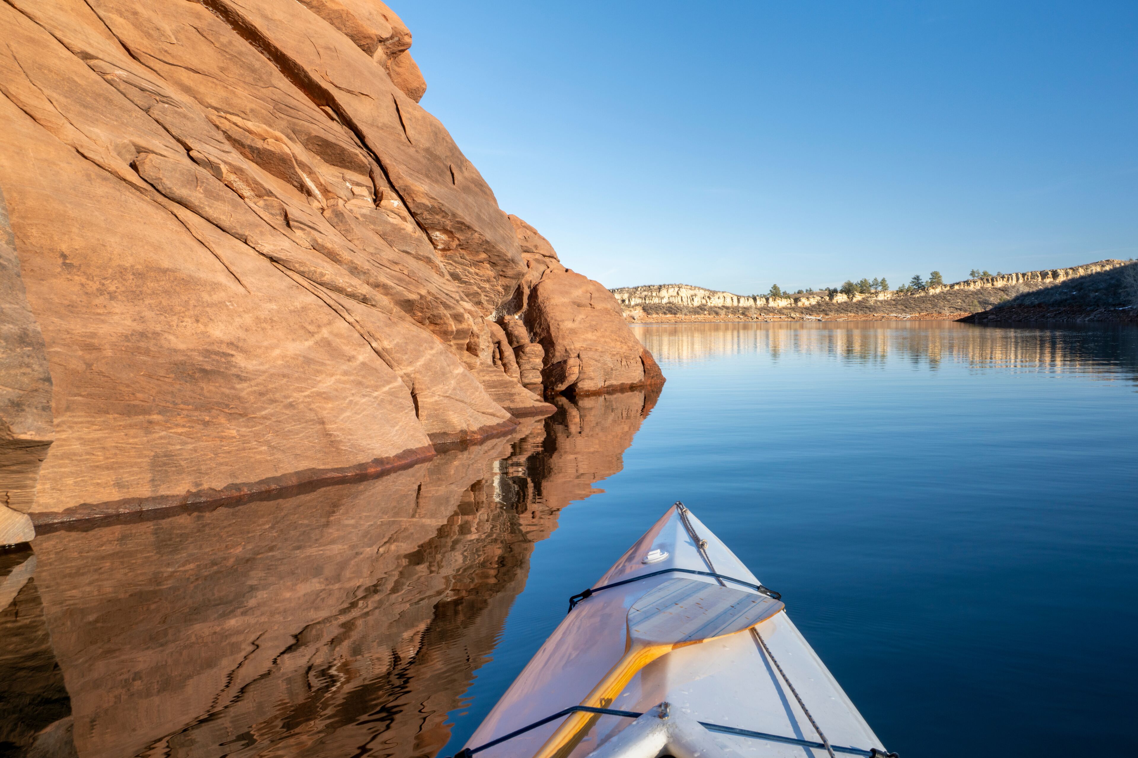 Horsetooth Reservoir at foothills of Rocky Mountains in northern Colorado - POV from expedtion canoe in warm winter scenery