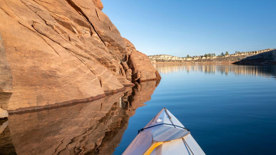 Horsetooth Reservoir at foothills of Rocky Mountains in northern Colorado - POV from expedtion canoe in warm winter scenery
