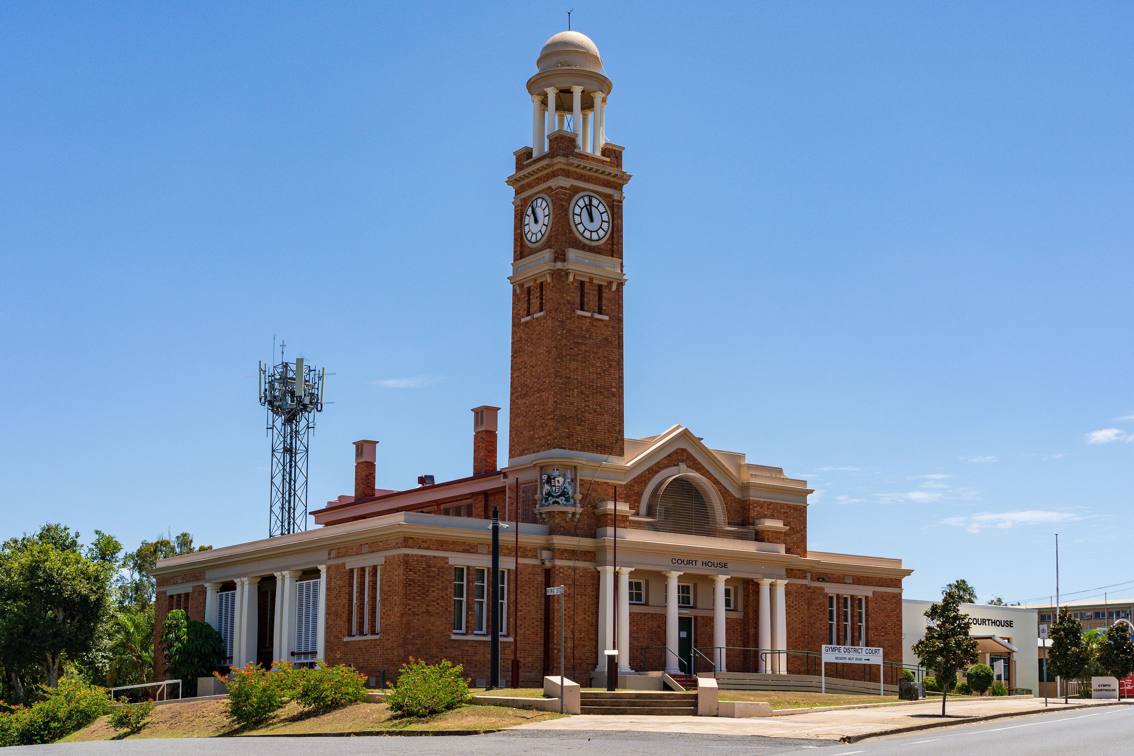 A courthouse with a clock tower, columns, and a sign reading "Court House."