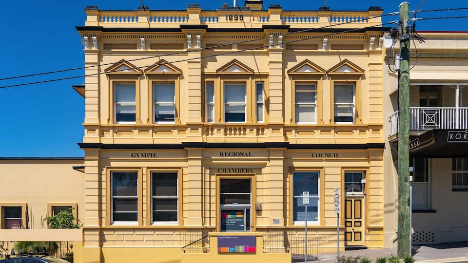 A yellow building with "Regional Council Chambers" on the facade.