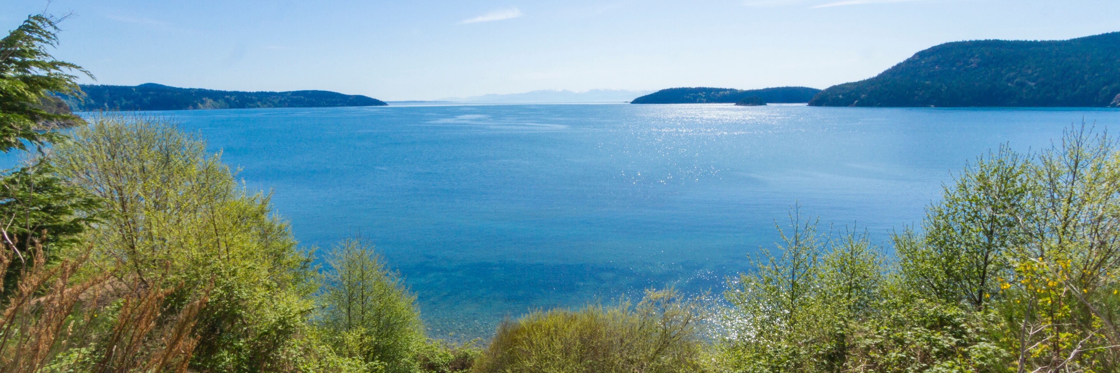 A calm lake surrounded by green hills.