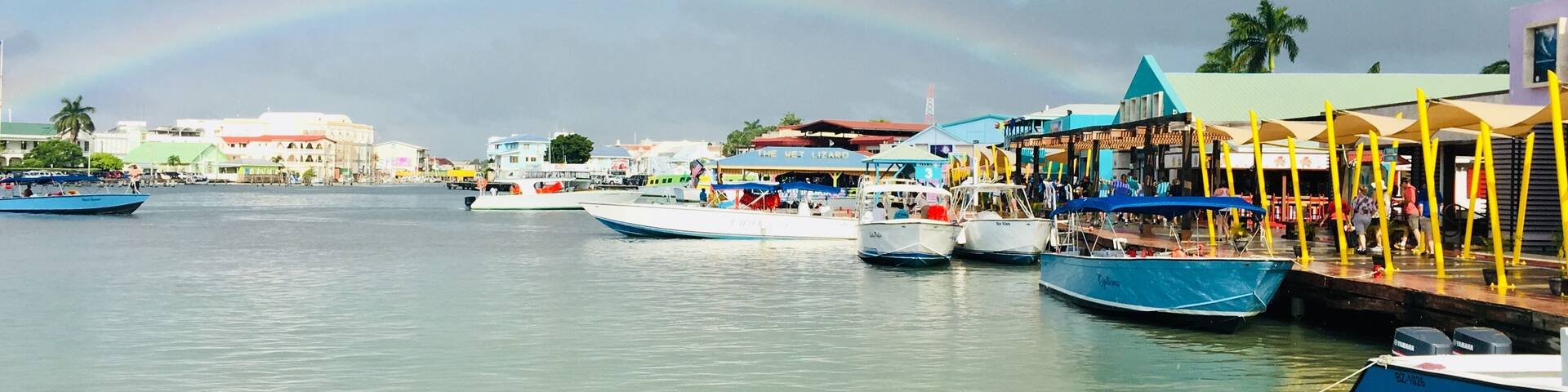 As soon as we reached the dock, it started to shower. The sun created this beautiful rainbow, which melted perfectly into the colorful Belize City. #culture #belize