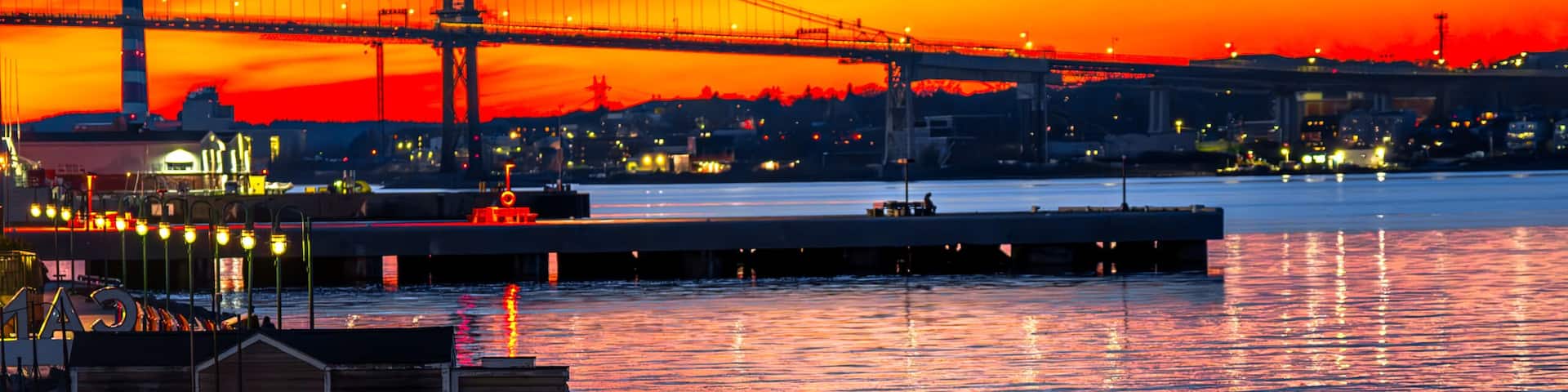 Halifax harbor sunset with Macdonald Bridge and waterfront lights