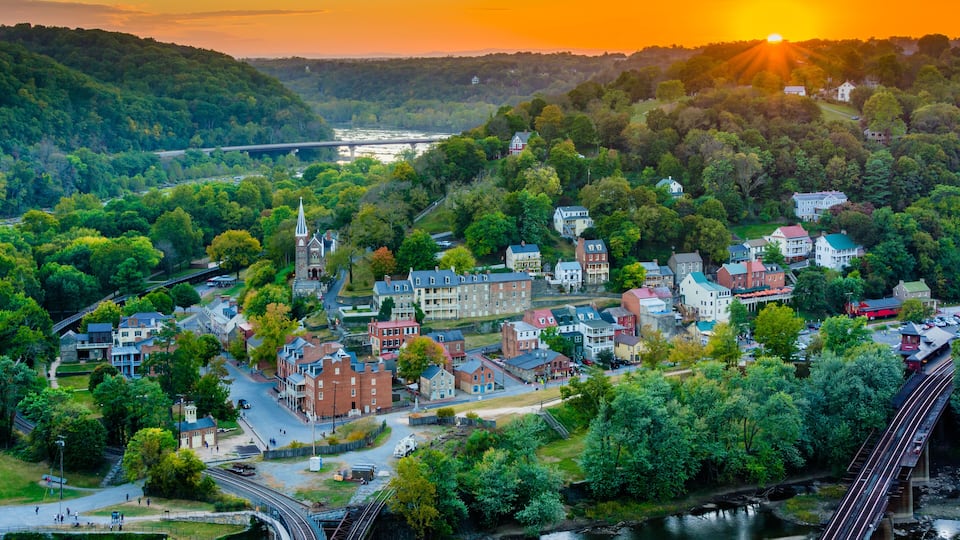 A town with a church, a bridge, and a river.
