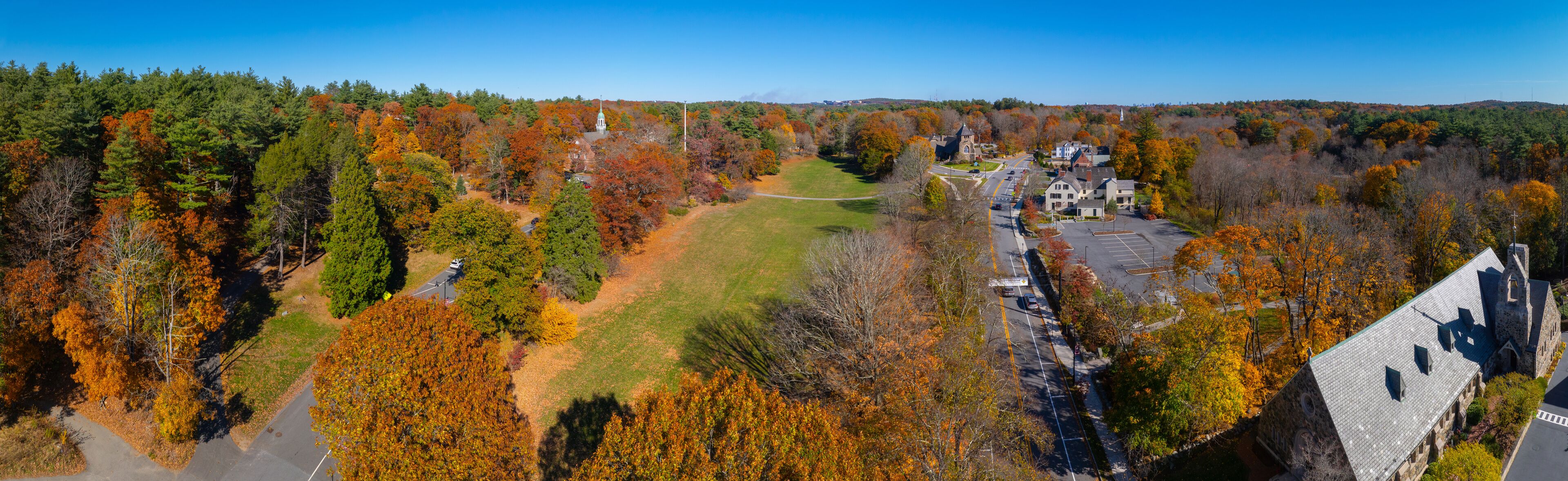 Weston historic town center aerial view including Town Hall at Lanson Park and First Parish Church in fall with foliage, Weston, Massachusetts MA, USA.  