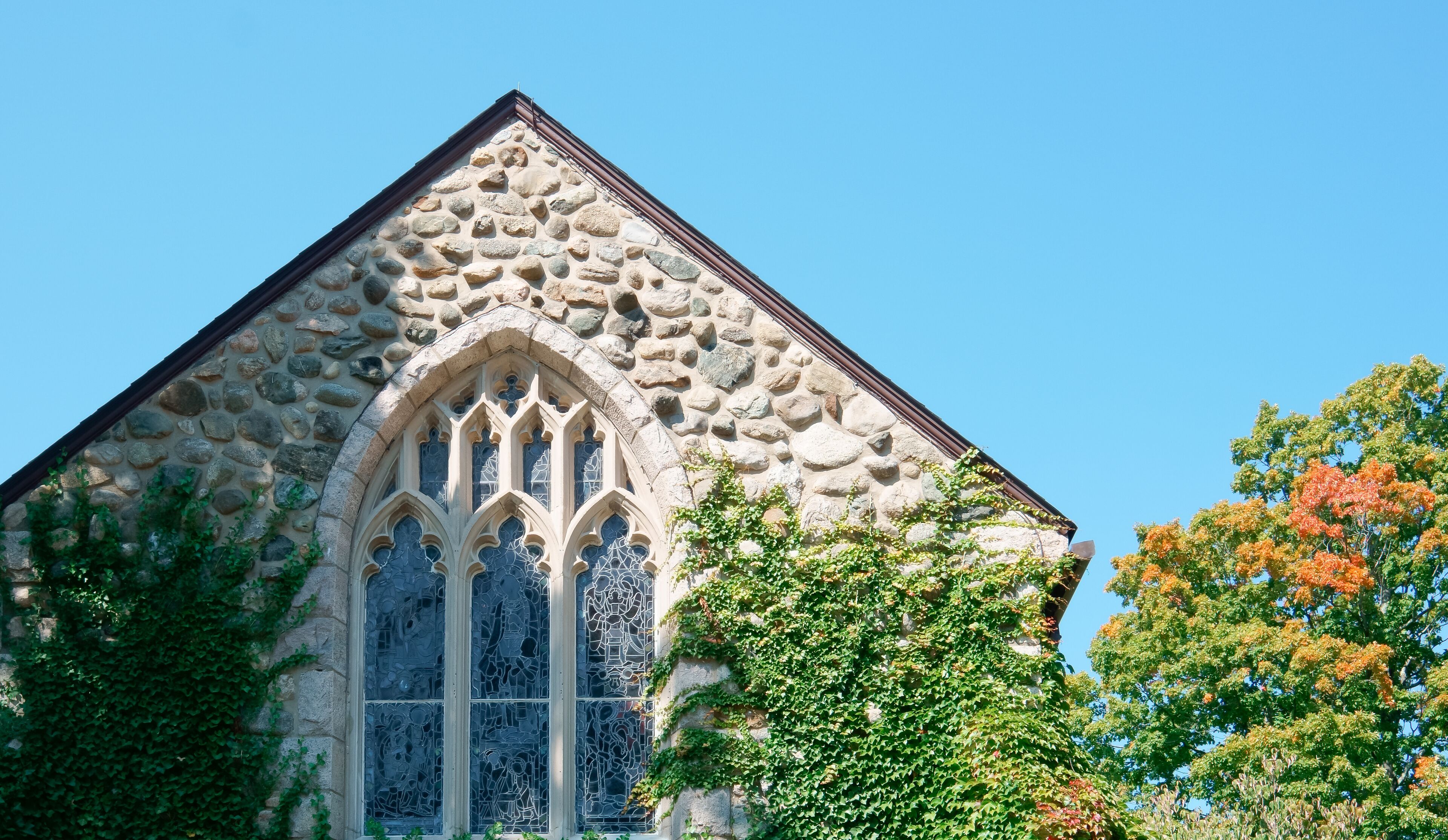 A stone church wall with Gothic window 