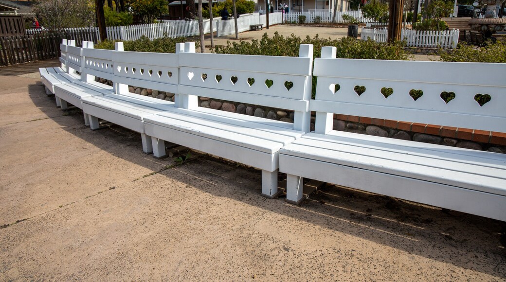 The white benches by the water fountain at the Old Poway Park in Poway, California.