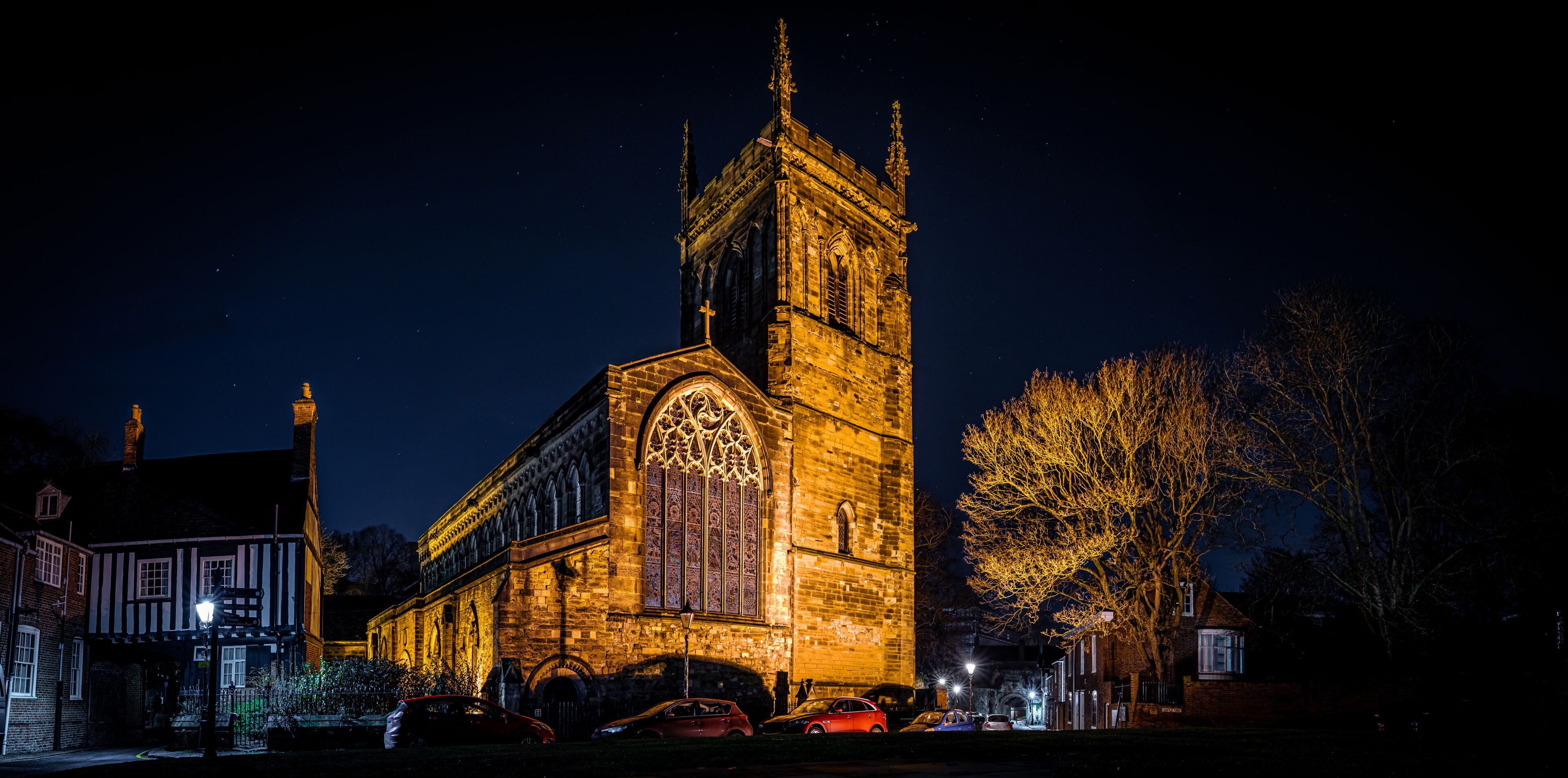 A Gothic-style church with a tall tower and intricate stained glass window.