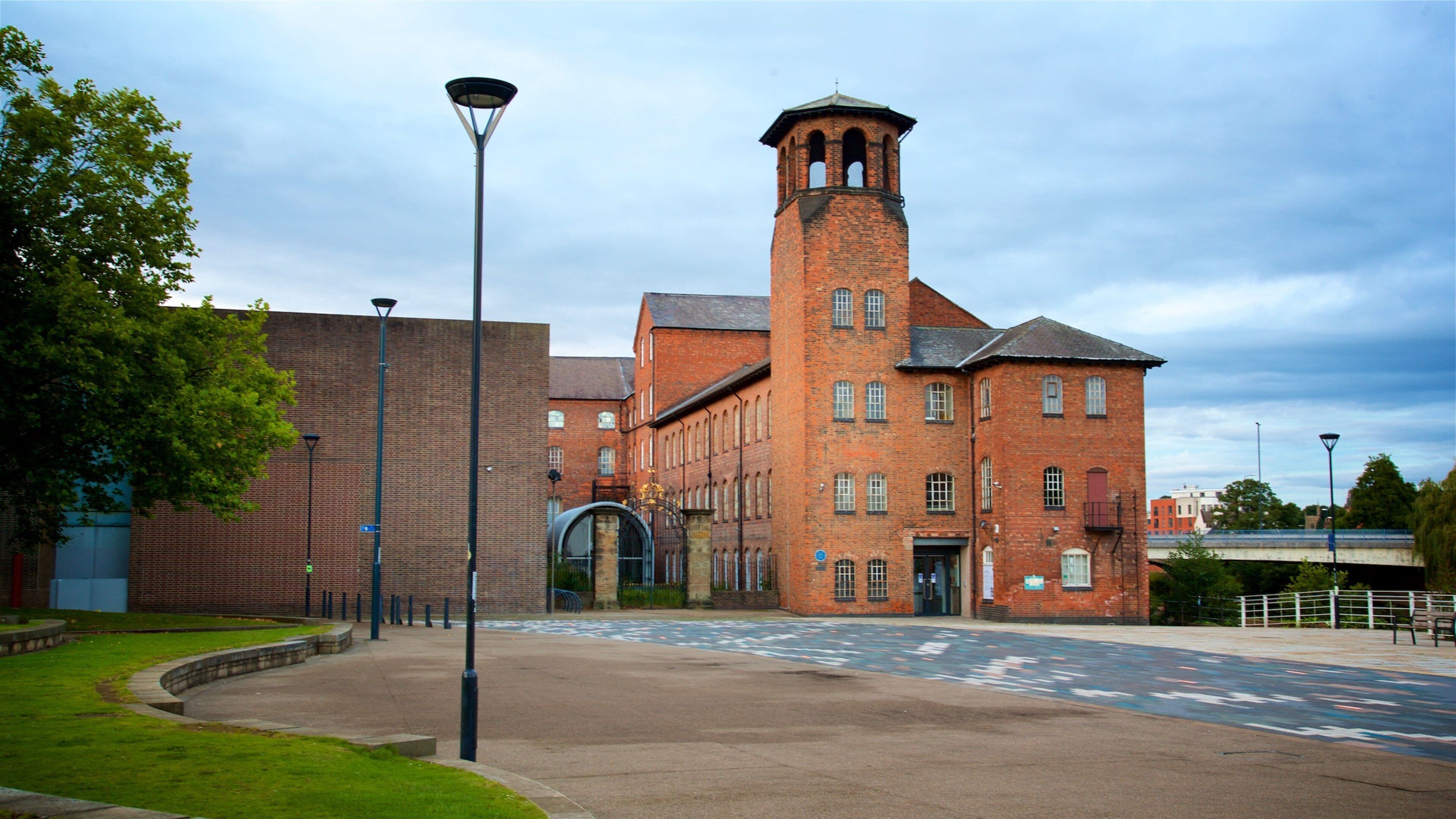 A large brick building with a tower and arched entrance.