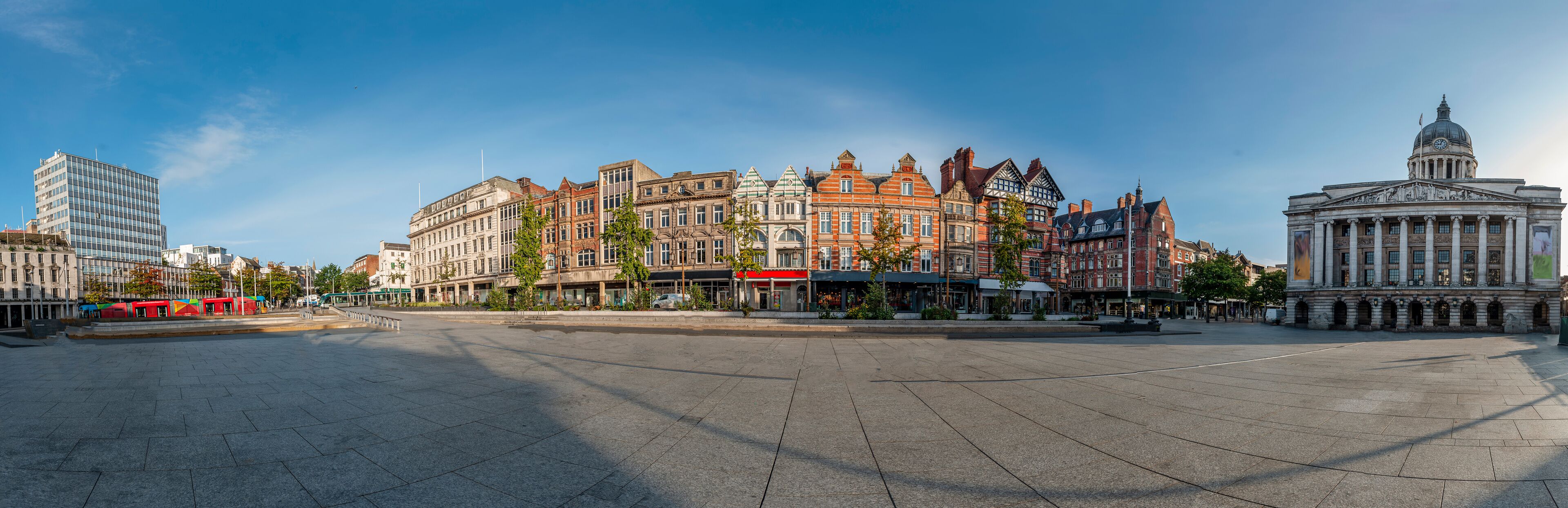 A wide city square with historic buildings and a prominent government building.