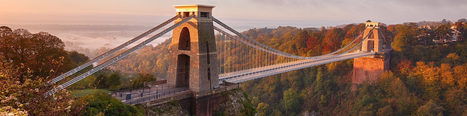 Clifton Suspension Bridge on an autumn morning as the sun rises and breaks through the clouds