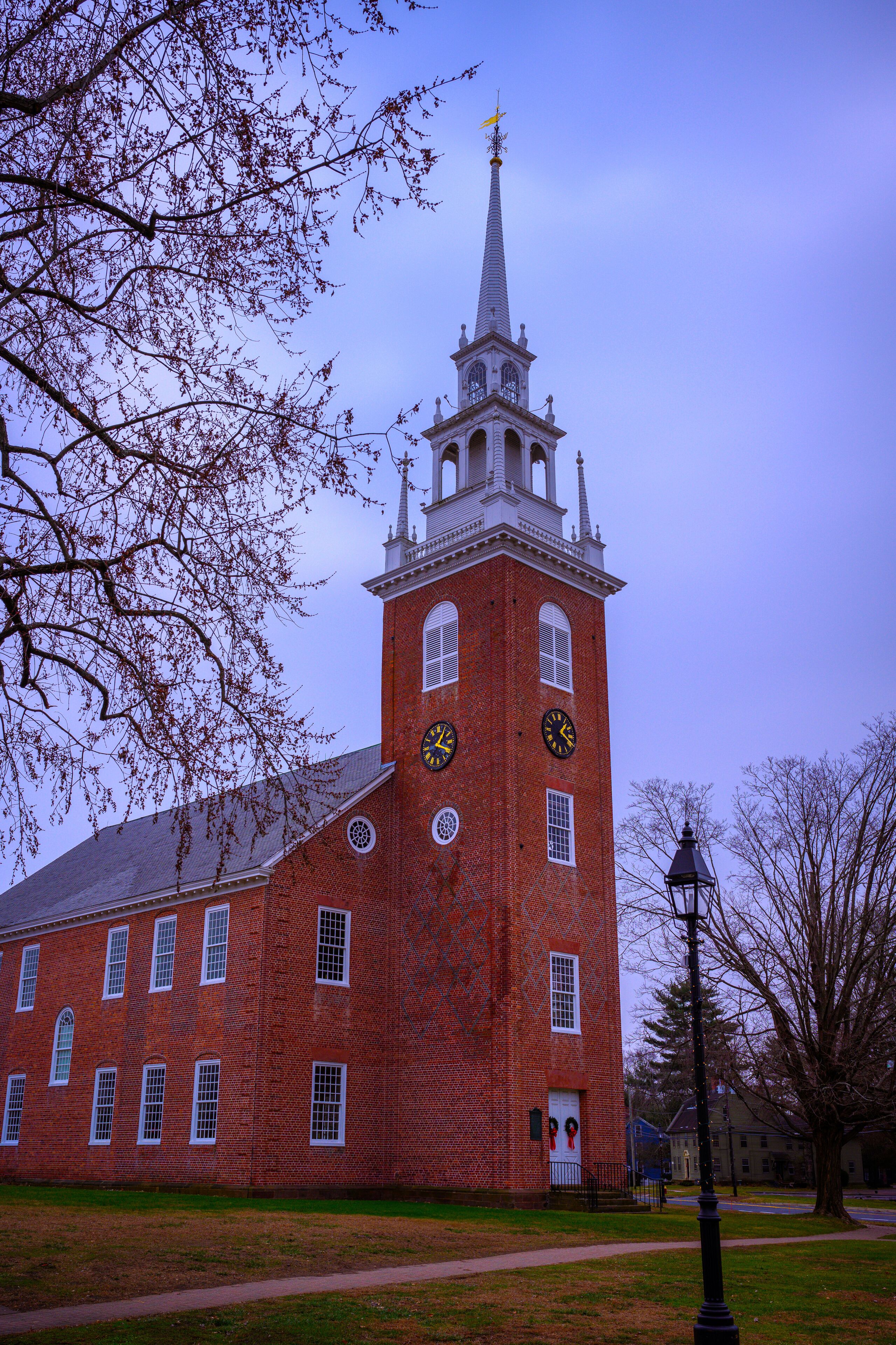 The First Church of Christ in Old Wethersfield, an American Colonial Era landmark red brick church built in 1635 with an architecturally distinctive white steeple, in Connecticut