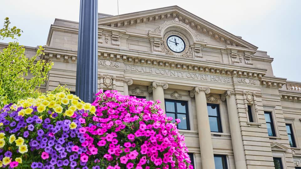 A building with columns and a clock, labeled 'DEKAIB COUNTY COURT HOUSE.'