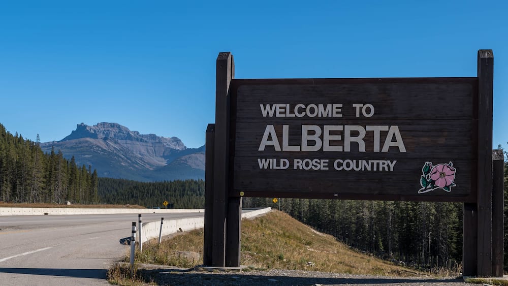 The Welcome to Alberta sign on the Trans Canada Highway rest stop on a sunny day