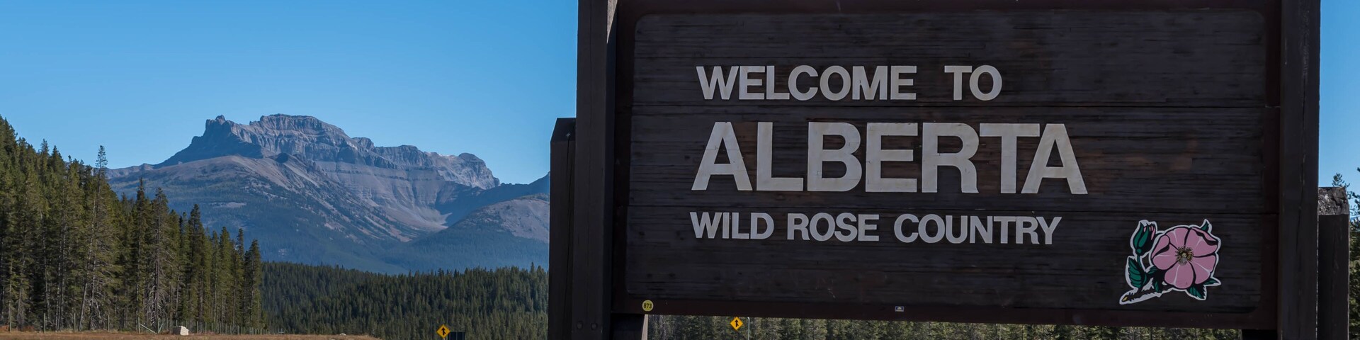 The Welcome to Alberta sign on the Trans Canada Highway rest stop on a sunny day