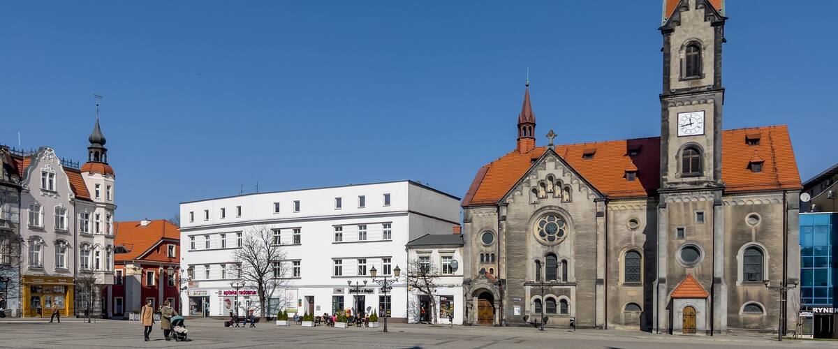 Tarnowskie Gory, Poland, March 22, 2022: The town square with a visible Evangelical-Augsburg Savior Church in Tarnowskie Góry and old houses.