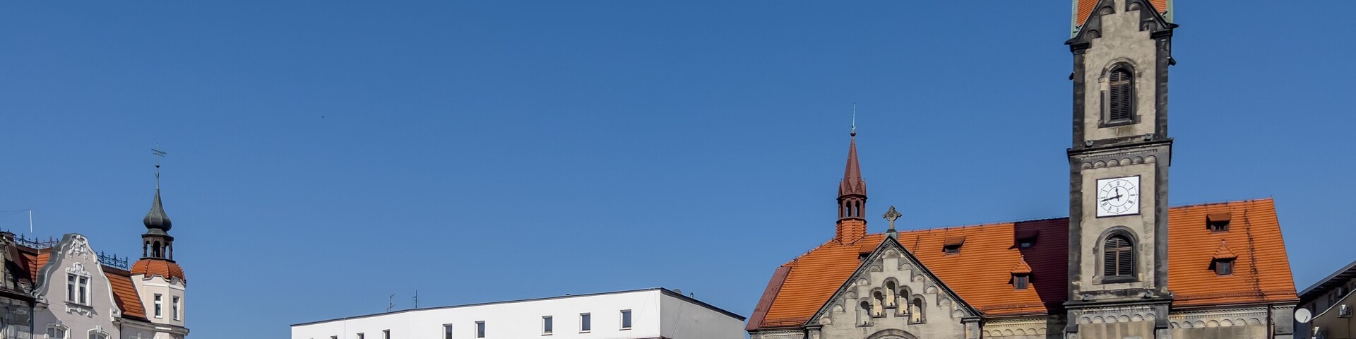 Tarnowskie Gory, Poland, March 22, 2022: The town square with a visible Evangelical-Augsburg Savior Church in Tarnowskie Góry and old houses.