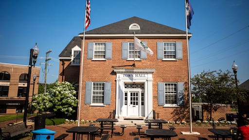 City Hall in Herndon, Virginia, with flags and blue sky.