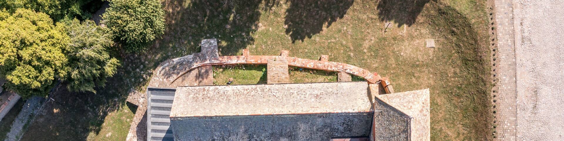 Aerial view of medieval Gothic Simontornya castle protecting the cross on the Sio river in Tolna county Hungary with restored donjon, palace, brick walls blue cloudy sky