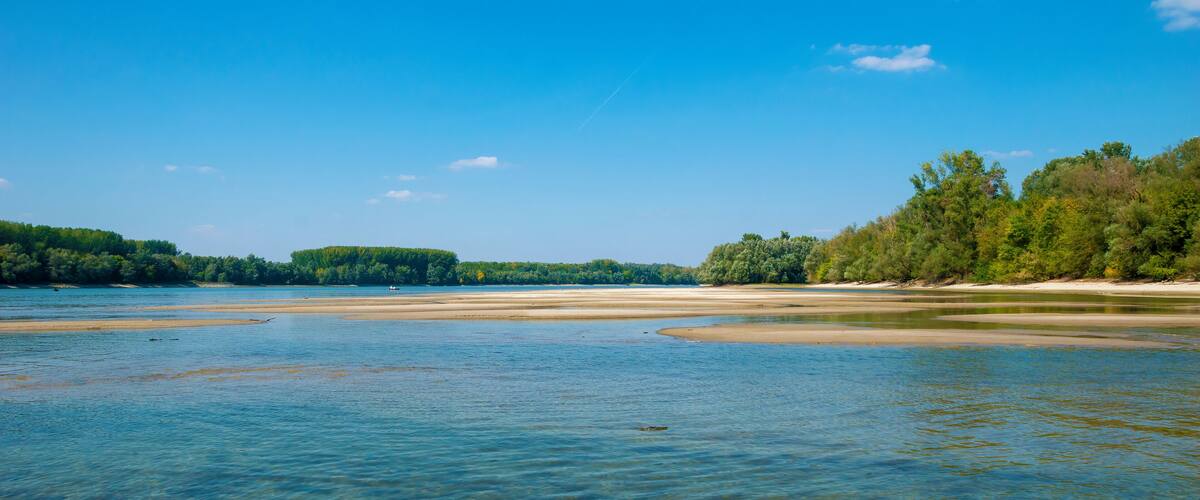 Danube sandbanks, low water level, on a late summer day, the forest surrounds the river