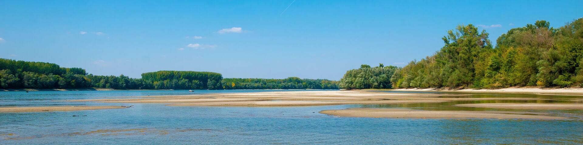 Danube sandbanks, low water level, on a late summer day, the forest surrounds the river