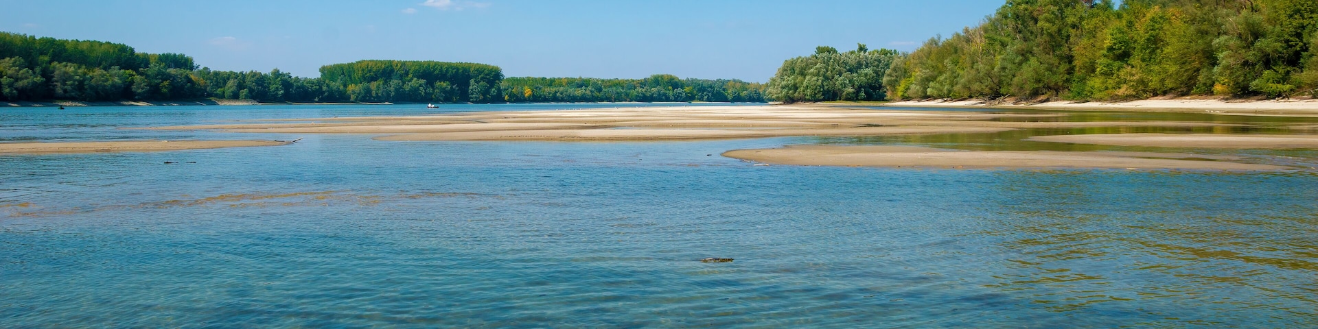 Danube sandbanks, low water level, on a late summer day, the forest surrounds the river