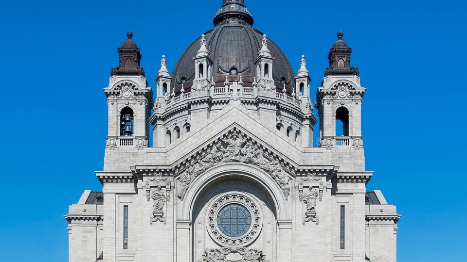 A large, ornate church with a prominent dome and multiple towers.