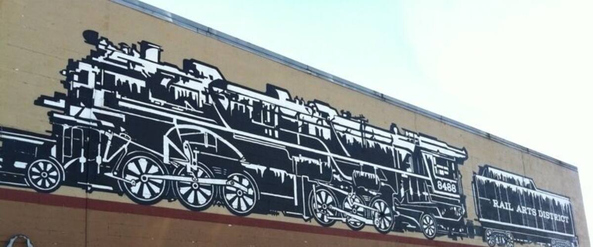 A mural of a train on a building.