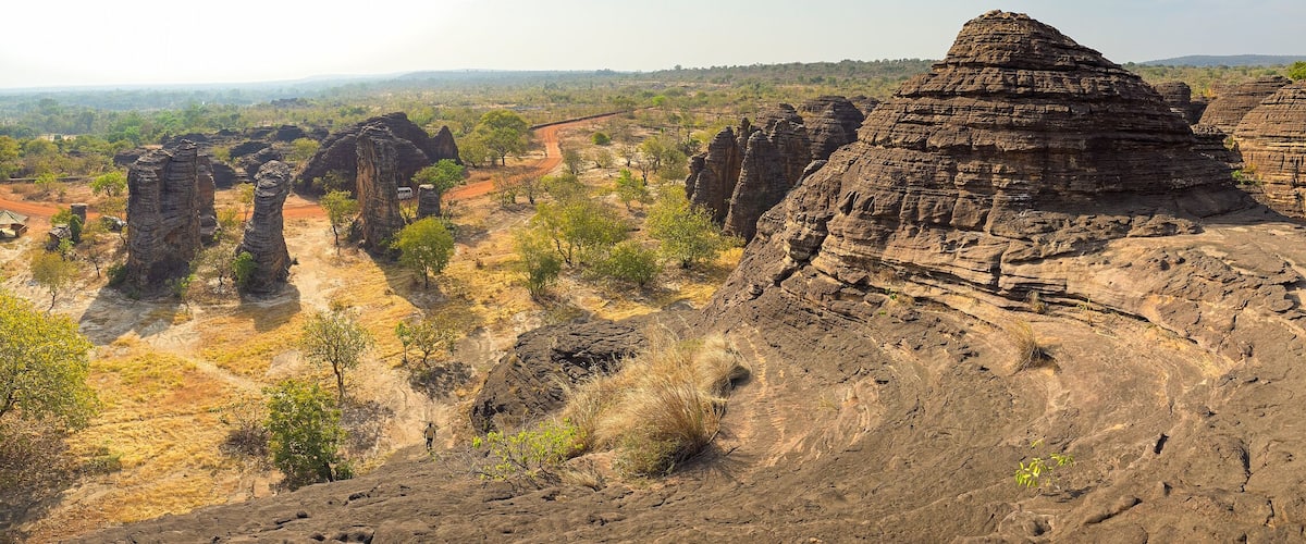 A landscape with prominent rock formations and a dirt path.