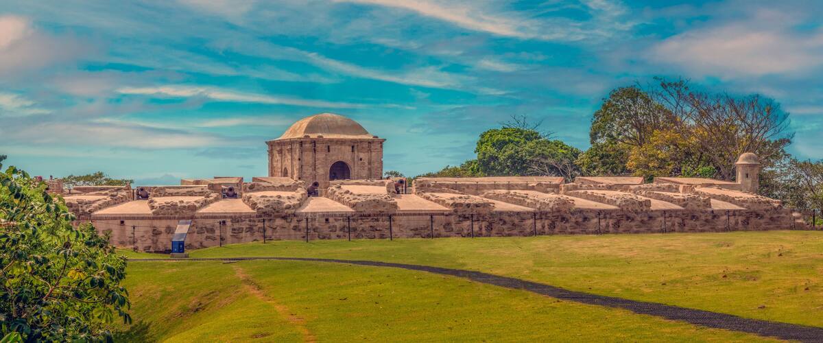 A historic stone fortress with a central dome and surrounding walls.