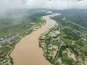Aerial view of a beautiful lake surrounded by lush greenery and meandering river, Yenegoa, Nigeria.