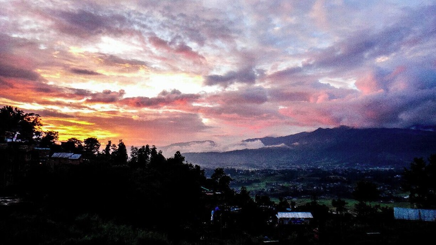 After visiting Bhaktapur, we took a bus up to see the ancient Hindu Vishnu temple Changu Narayan before it closed. It is considered to be the oldest temple in Nepal with pieces dating back to 325 A.D.
We were lucky because it had just been storming hours before but we managed to see this sunset. This overlooks the Changu village.
Warning: there seems to be a "tourist price" for these buses. We found out where everyone is charged 15-20 RPS we were charged 50. They do this because you can't understand any better. The difference in US dollars is only cents haha but still, I hate that feeling of being ripped off =S