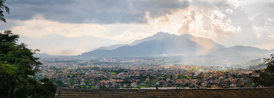 Panorama of Kathmandu valley, with cloudy sky and sunset, town and hills, from Shivapuri Nagsrjun National Park in Nepal.