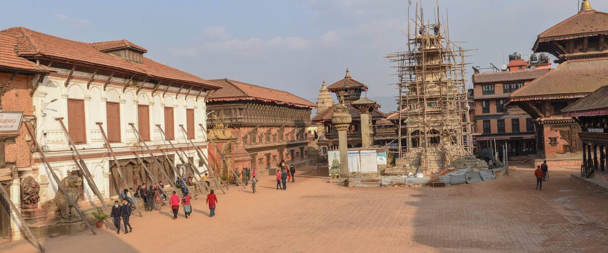 A historic street with traditional architecture, including a National Art Museum and a temple under construction.