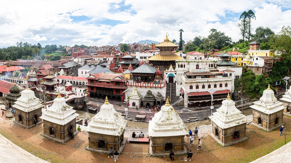 A historic city with ancient temples and a prominent golden-domed structure.